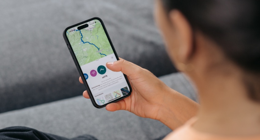 Une utilisatrice de l'application eBikeFlow planifie un itinéraire vélo depuis son smartphone.